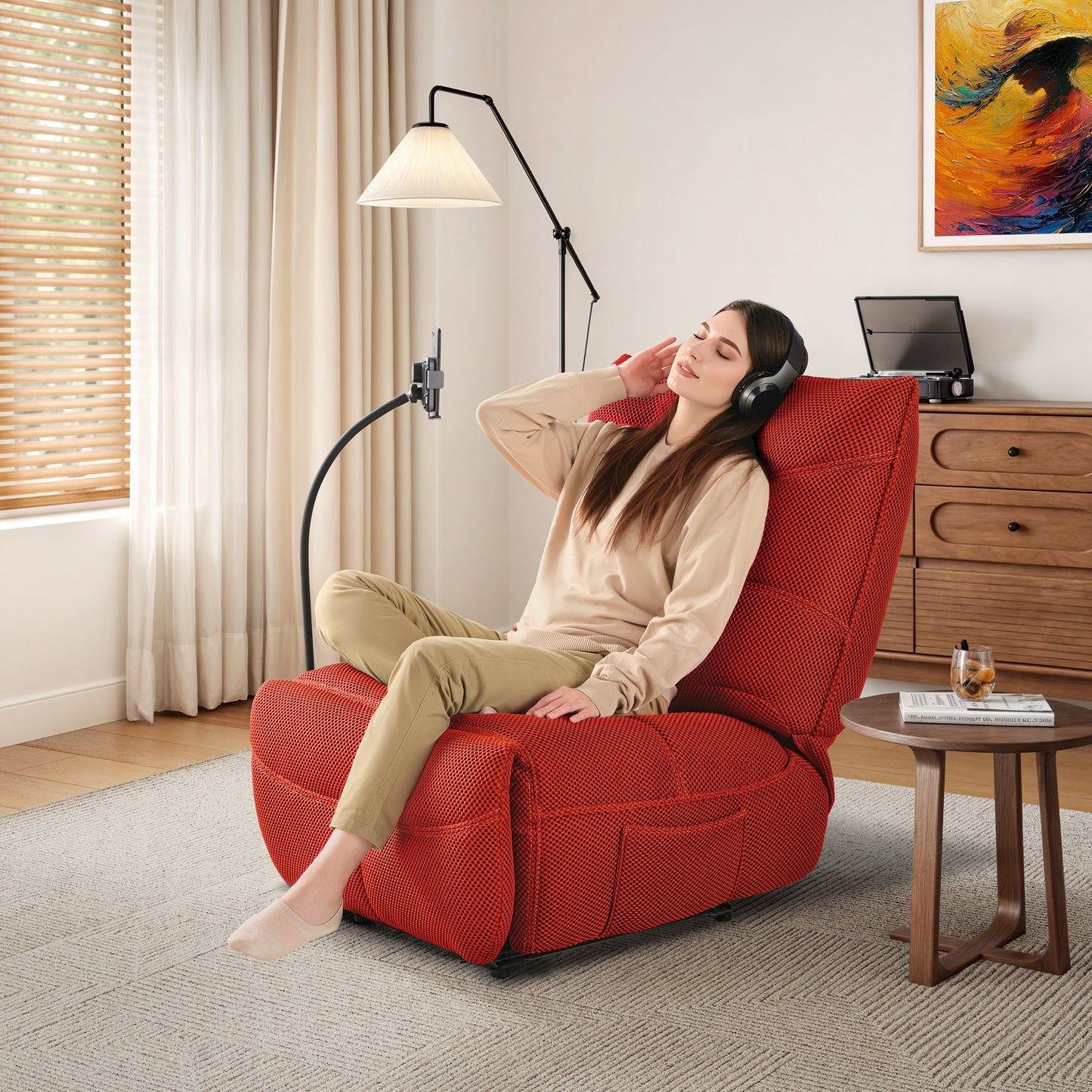 Woman Relaxing in a Red Techno 3D Fabric Linx Power Glider Recliner With Headphones, Modern Living.