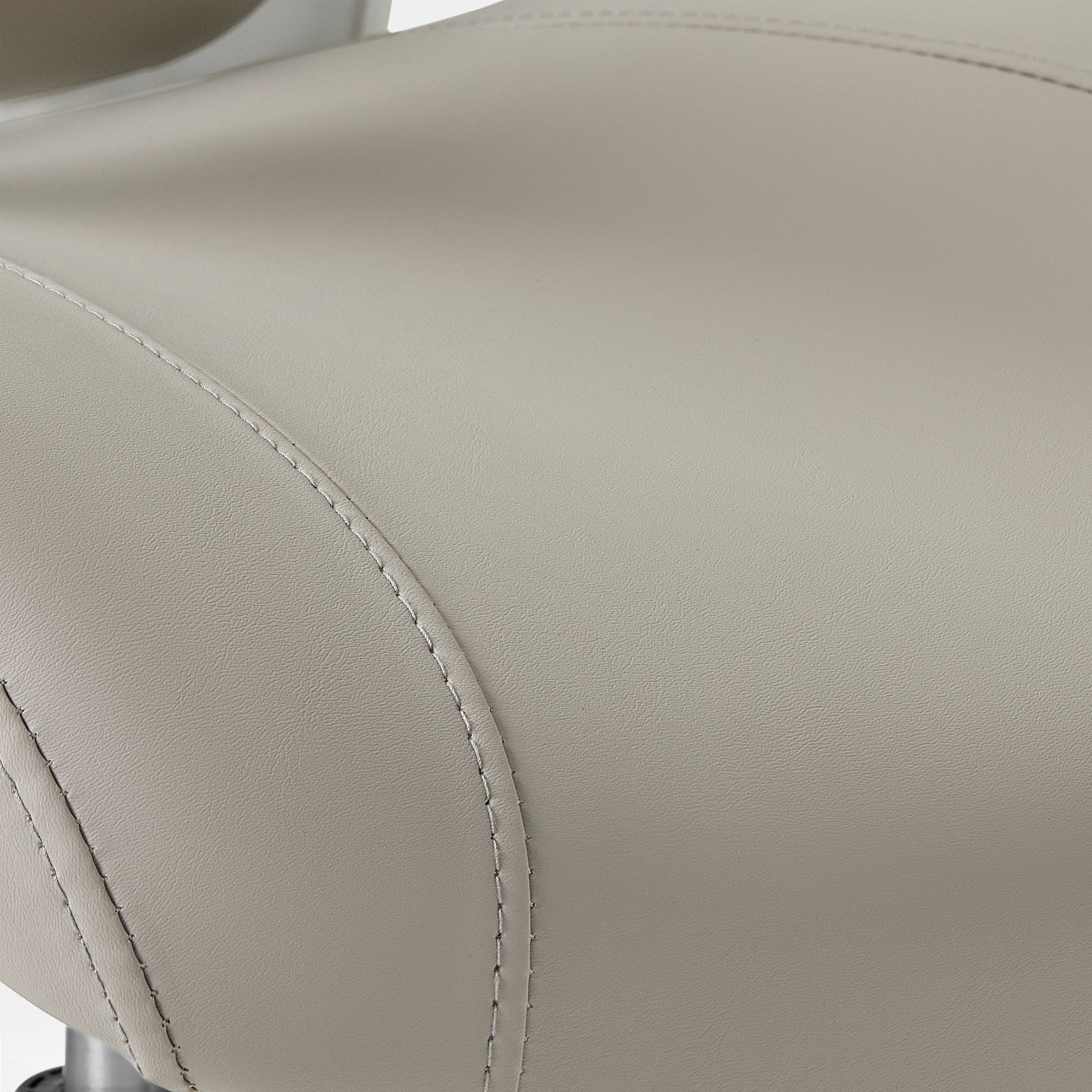 Eureka Ergonomic Close-up of light grey PU leather seat on Vera ergonomic office chair, showing texture and white stitching detail.