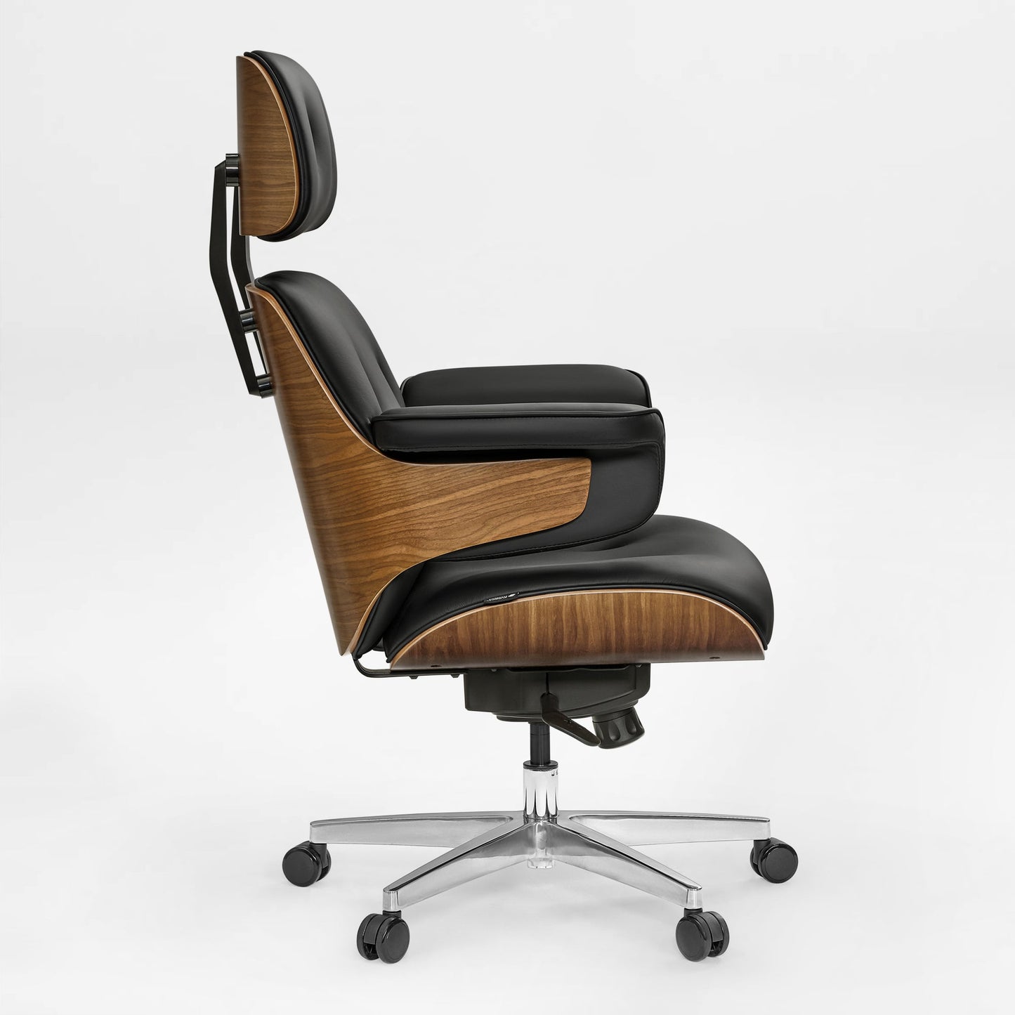 Eureka Ergonomic Mathias executive office chair with walnut veneer and black Napa leather, side view on a silver five-wheel base.