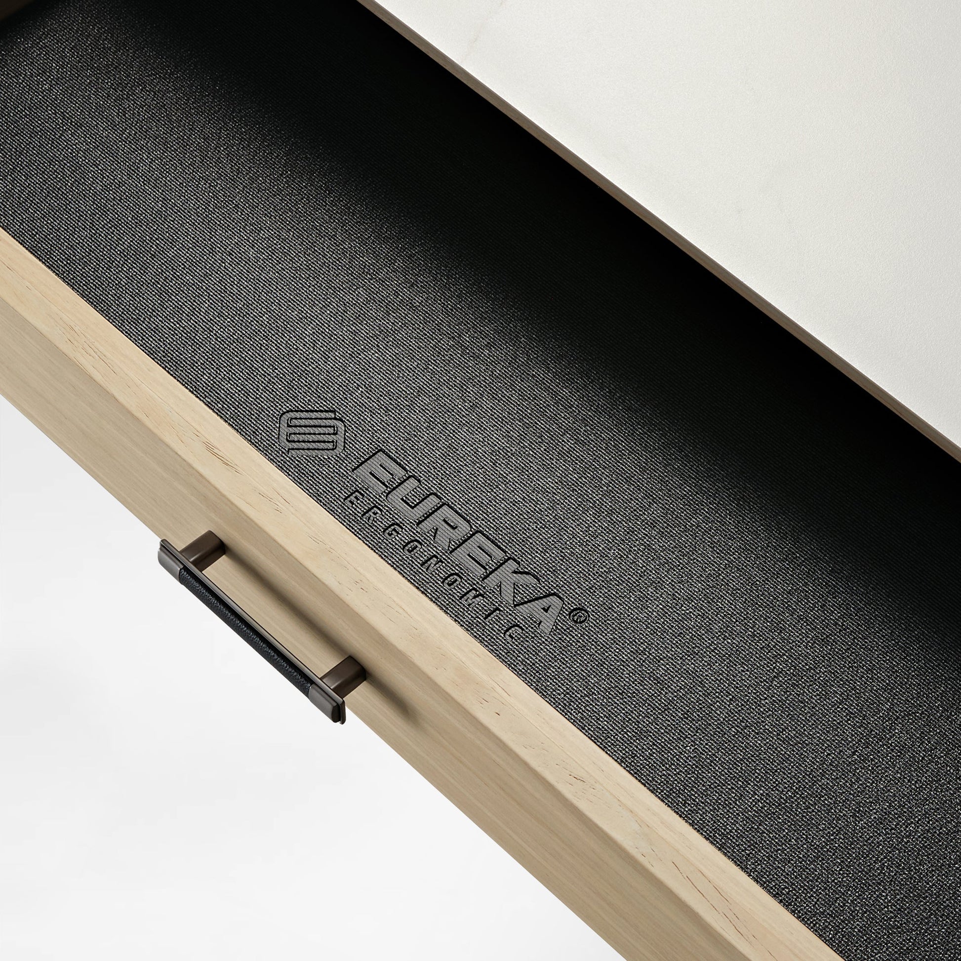 Eureka Ergonomic Desk Drawer Detail, Black Leather Grip, Wood, and Logo.