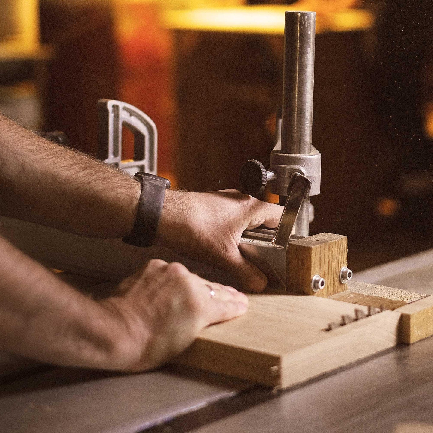 Craftsman Using Saw On Wood for Eureka Ergonomic Desk Components, Focusing On Precision and Craftsmanship.
