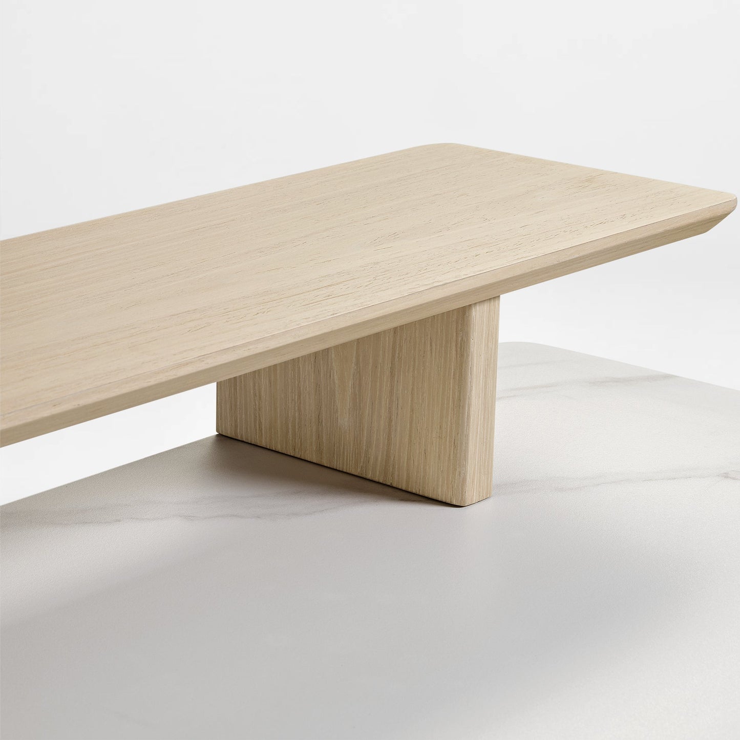 Eureka Ergonomic Ark Pro Desk Detail: Wooden Shelf With Wood Grain, Light Color, Atop a Black Sintered Stone Desk.