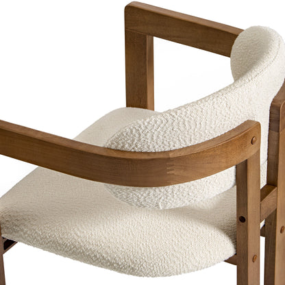 Eureka Ergonomic Close-up of Elle bouclé dining chair in ivory with walnut wood frame, mid-century modern design.
